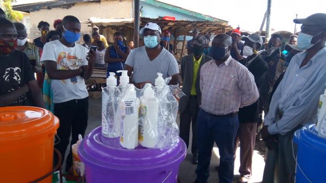 Mr. Chali Chilombo, MP (Centre) donates assorted materials to a market in Nchanga Constituency