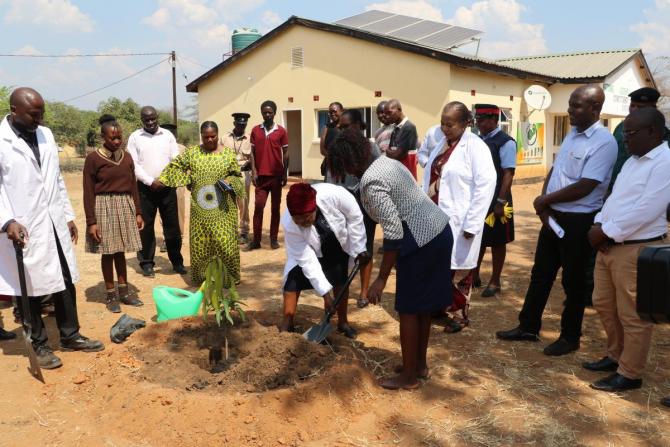 First Deputy Speaker, Hon. Malungo Chisangano, MP plants a tree at the Rufunsa Constituency Office as Hon. Sheal Mulyata looks on.