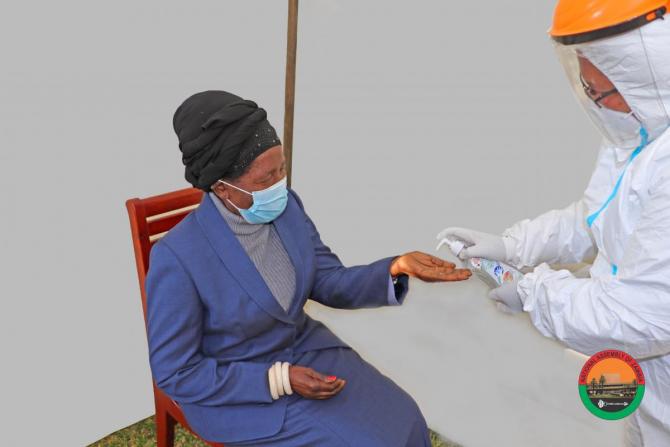 Her Honour the Vice President, Madam Inonge Wina, MP, being sanitized after the Covid-19 Swab at Parliament Buildings